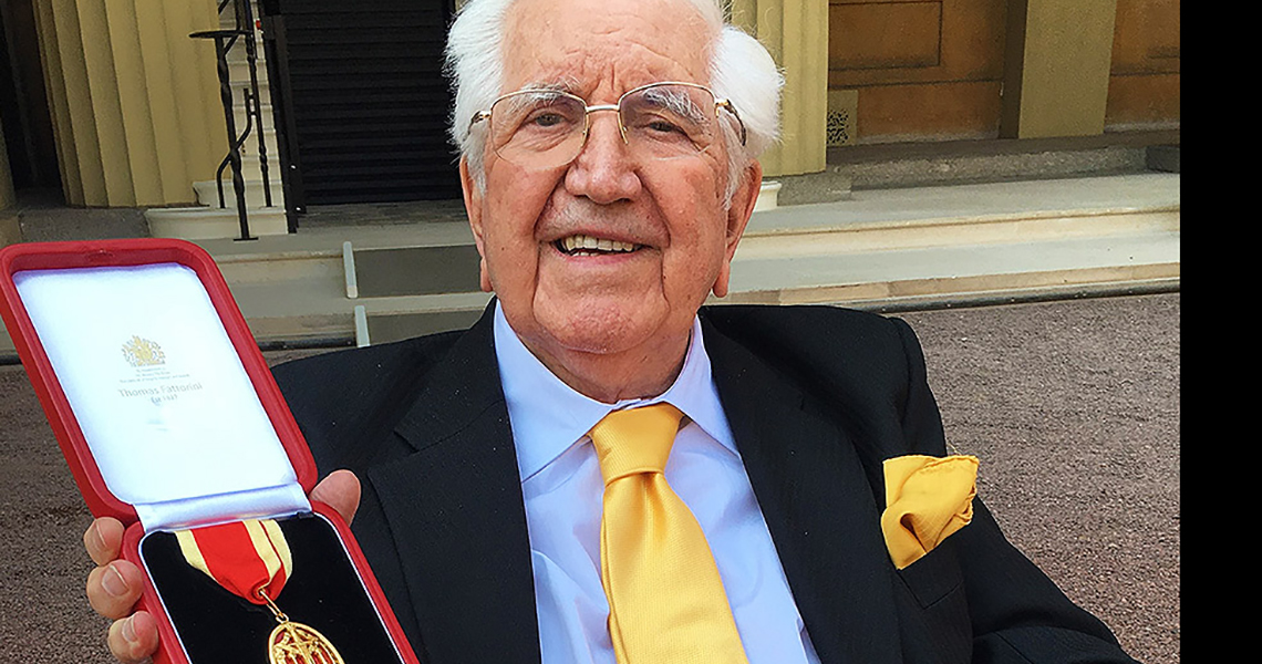 Sir Jack Petchey holding a medal