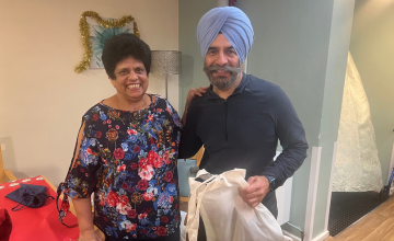 Cllr Jas Athwal giving a warm pack to a woman who lives in a care home