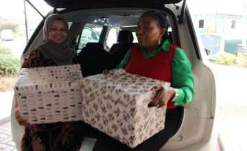 Council staff with hampers by a car