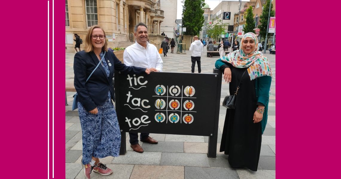 Council staff standing by play equipment in Ilford town centre