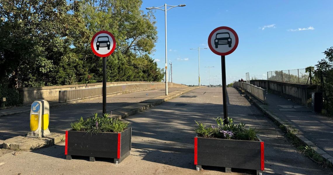 Broadmead Road Bridge with planters and signage