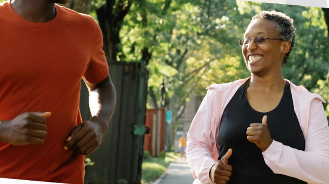 Two people running on a residential street, smiling.