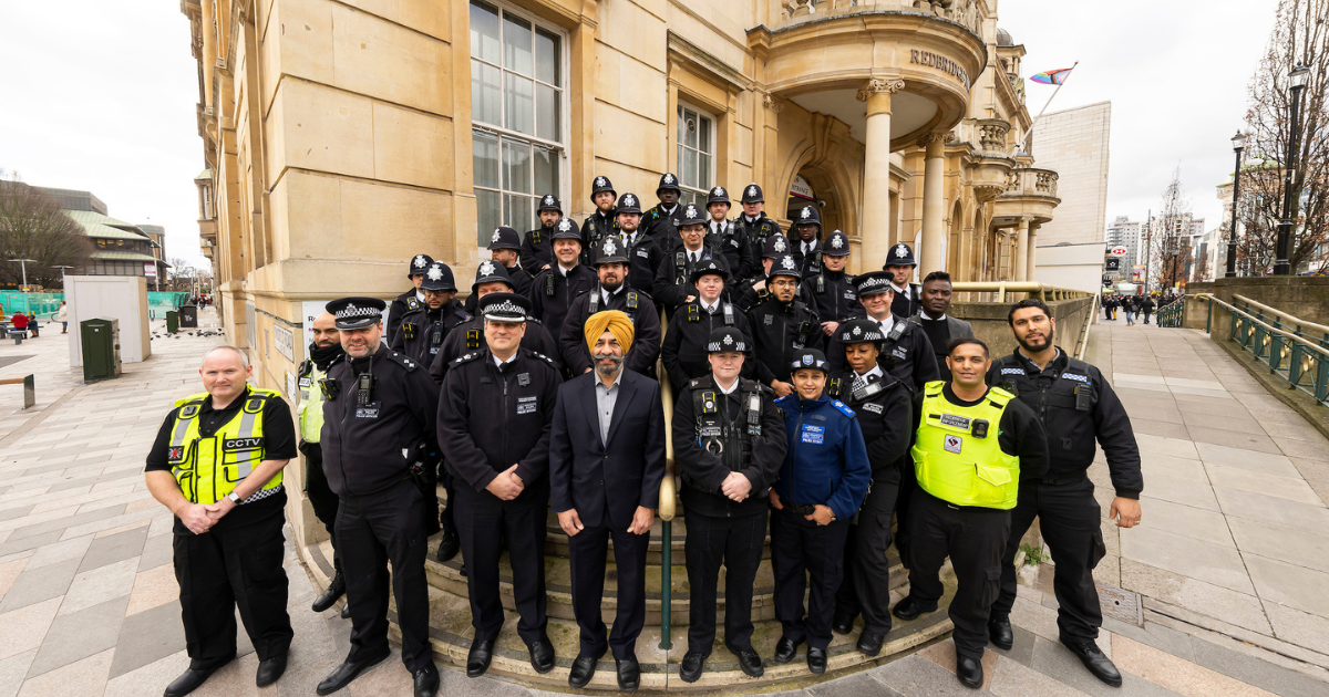 25 new police officers stand on the steps of Redbridge Town Hall with Councillor Jas Athwal